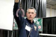 Troy holding up a lateral extension shoe at Michiana Equine Event