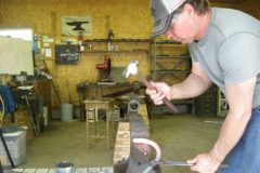 Dru turning the branch of a handmade shoe