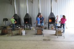 Students lighting coke forges