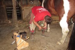 Sam nailing on a shoe with a pad