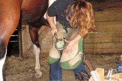 Zoe nailing on a shoe with a pad