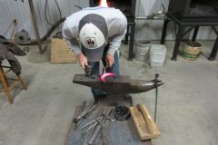 Jayson punching holes in handmade shoe